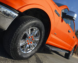 ColorLugs orange colored lug covers on silver truck wheel